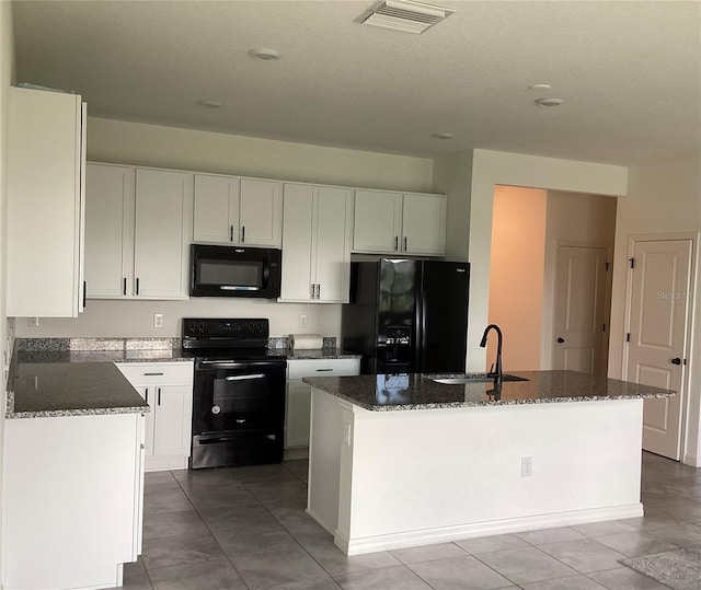 12630 Aston Dr, Hudson, FL 34669 - kitchen featuring a sink, dark stone counters, white cabinetry, visible vents, and black appliances
