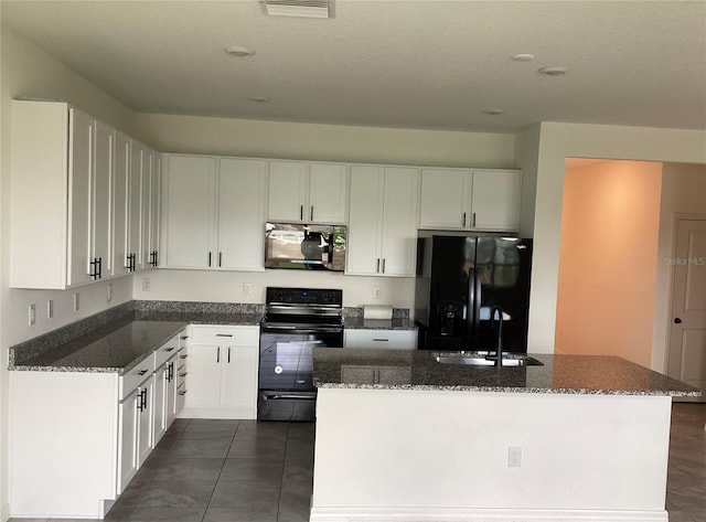 12630 Aston Dr, Hudson, FL 34669 - kitchen featuring a sink, white cabinets, black appliances, and dark stone countertops