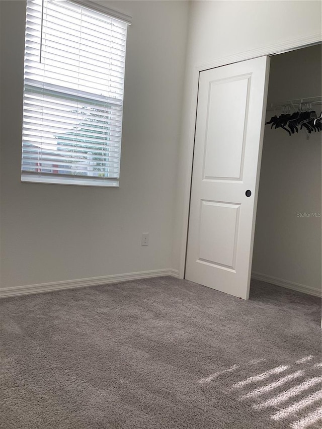 12630 Aston Dr, Hudson, FL 34669 - unfurnished bedroom featuring carpet floors, baseboards, and a closet