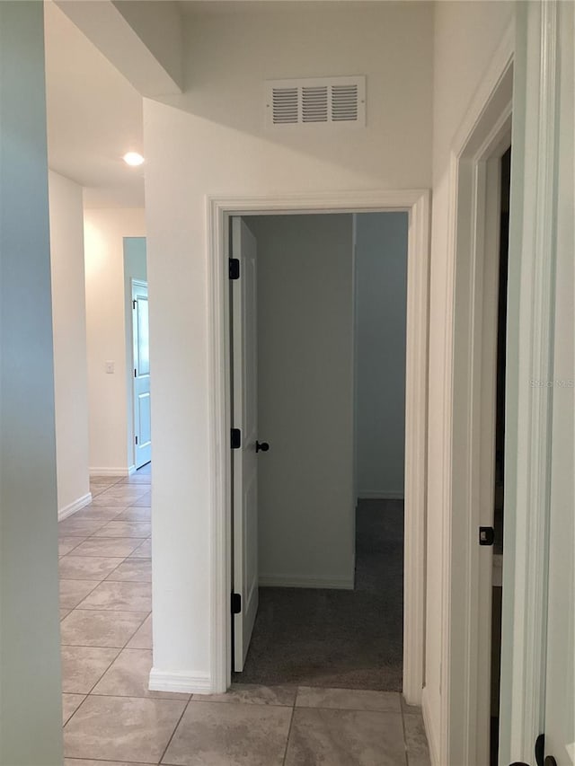 12630 Aston Dr, Hudson, FL 34669 - hallway with visible vents, baseboards, and light tile patterned flooring