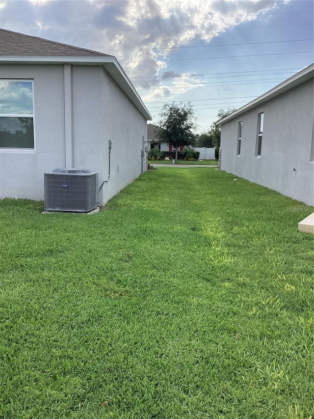 12630 Aston Dr, Hudson, FL 34669 - view of yard featuring central AC unit