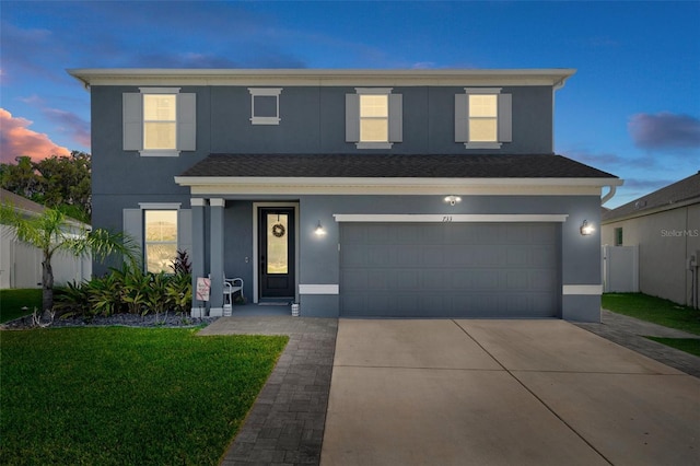 733 Old Windsor Way, Spring Hill, FL 34609 - traditional-style house with a garage, a yard, stucco siding, and driveway