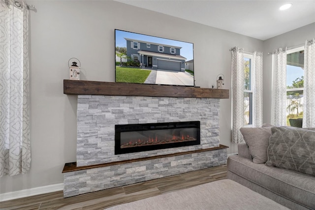 733 Old Windsor Way, Spring Hill, FL 34609 - living area featuring baseboards, a stone fireplace, recessed lighting, and wood finished floors