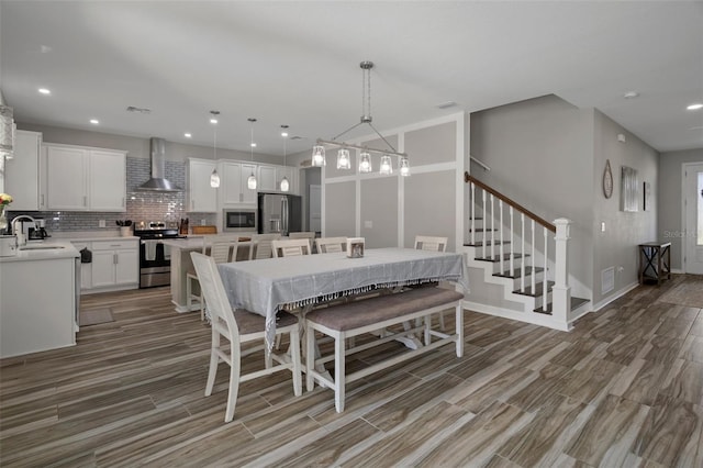 733 Old Windsor Way, Spring Hill, FL 34609 - dining area with stairs, recessed lighting, visible vents, and wood finished floors