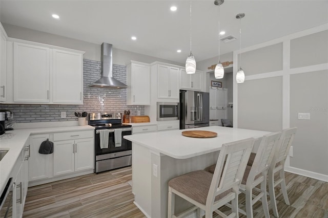 733 Old Windsor Way, Spring Hill, FL 34609 - kitchen featuring wall chimney range hood, backsplash, stainless steel appliances, and visible vents