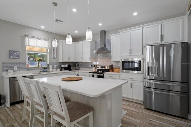 733 Old Windsor Way, Spring Hill, FL 34609 - kitchen featuring visible vents, decorative backsplash, wall chimney exhaust hood, a sink, and stainless steel appliances