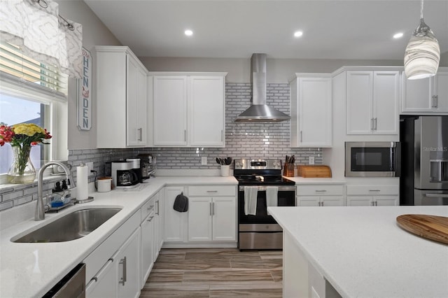 733 Old Windsor Way, Spring Hill, FL 34609 - kitchen featuring white cabinets, stainless steel appliances, a sink, and wall chimney exhaust hood