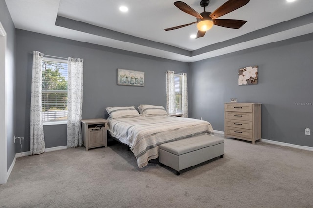 733 Old Windsor Way, Spring Hill, FL 34609 - bedroom with light carpet, baseboards, ceiling fan, recessed lighting, and a tray ceiling