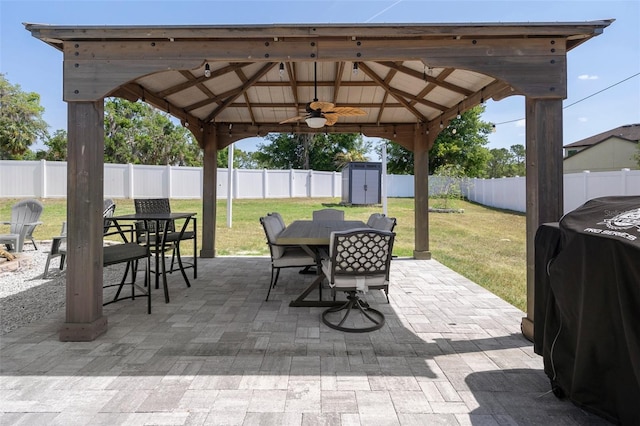 733 Old Windsor Way, Spring Hill, FL 34609 - view of patio featuring outdoor dining area, a gazebo, an outdoor structure, a fenced backyard, and a shed