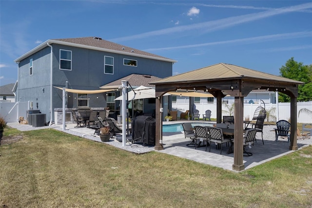 733 Old Windsor Way, Spring Hill, FL 34609 - rear view of house with a lawn, a gazebo, and a fenced backyard
