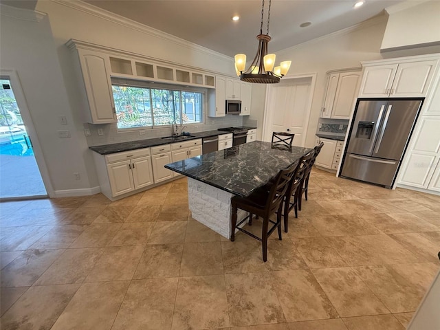 210 S Hale Ave, Tampa, FL 33609 - kitchen with stainless steel appliances, ornamental molding, tasteful backsplash, a breakfast bar, and recessed lighting