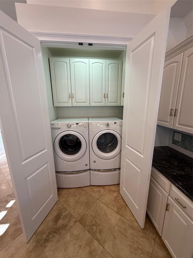 210 S Hale Ave, Tampa, FL 33609 - laundry area featuring cabinet space, independent washer and dryer, and light tile patterned flooring