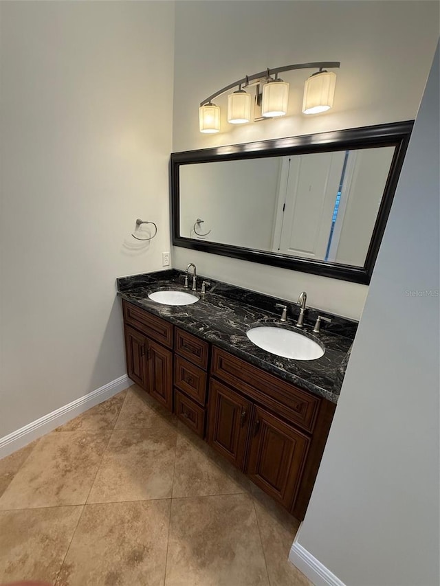 210 S Hale Ave, Tampa, FL 33609 - bathroom featuring baseboards, double vanity, and tile patterned floors