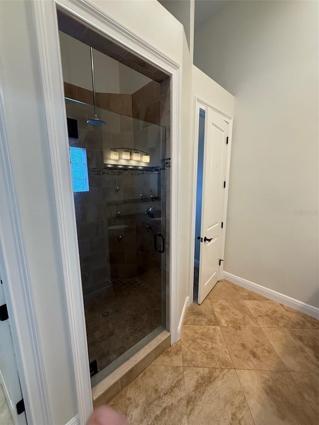210 S Hale Ave, Tampa, FL 33609 - full bath with a shower stall, baseboards, and tile patterned flooring