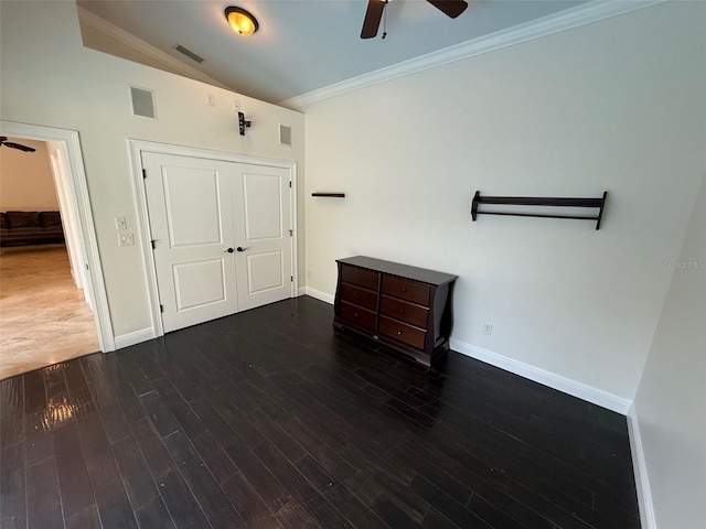 210 S Hale Ave, Tampa, FL 33609 - unfurnished bedroom with vaulted ceiling, baseboards, crown molding, wood finished floors, and a closet