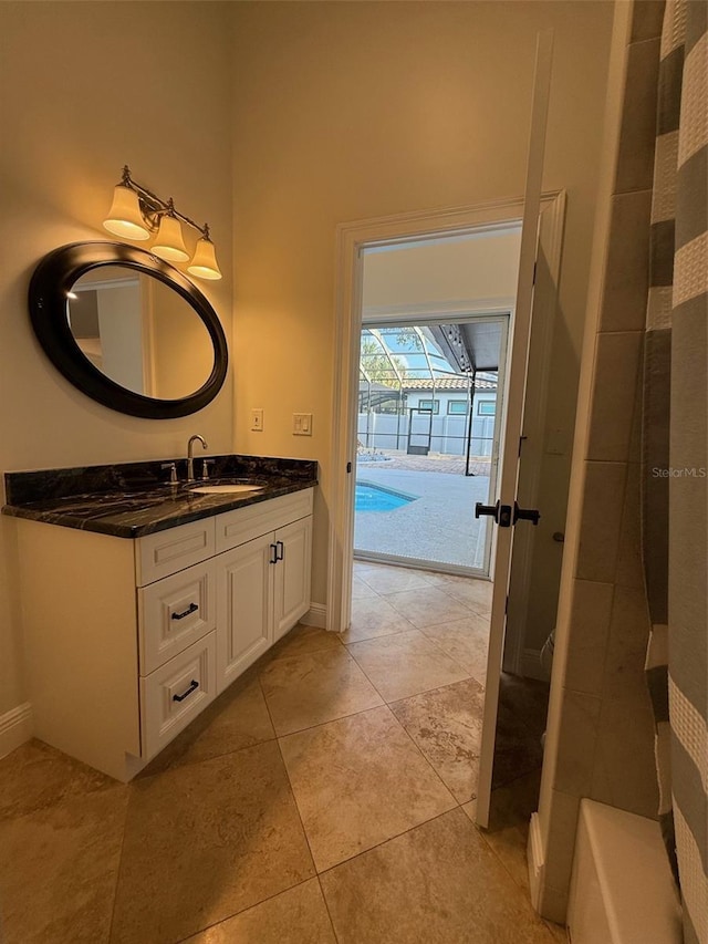 210 S Hale Ave, Tampa, FL 33609 - full bath with vanity, baseboards, tile patterned floors, and a shower