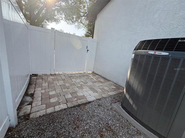210 S Hale Ave, Tampa, FL 33609 - view of patio featuring cooling unit and a gate