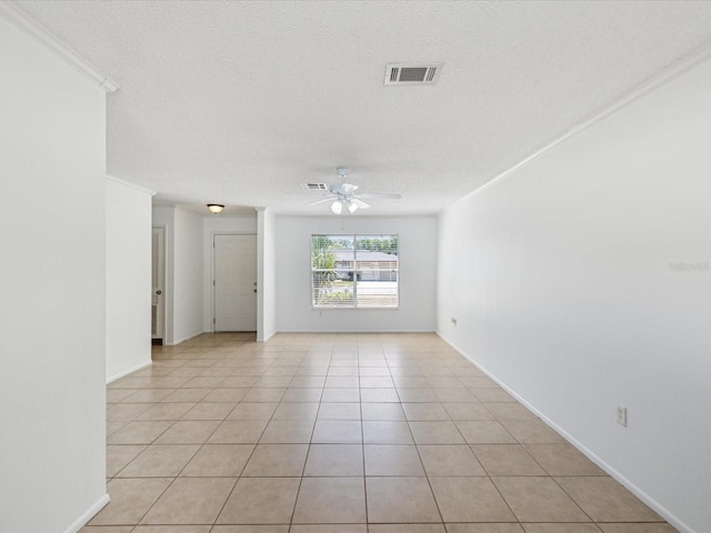 spare room featuring visible vents, a textured ceiling, ceiling fan, and light tile patterned floors