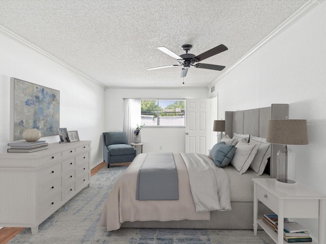 bedroom featuring ornamental molding, a ceiling fan, and a textured ceiling