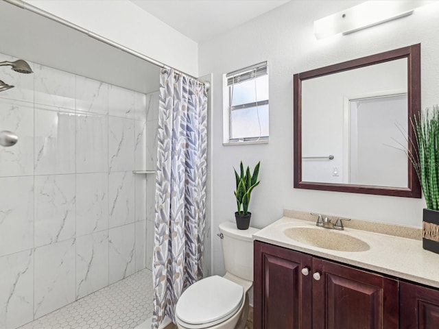 bathroom featuring toilet, tiled shower, and vanity