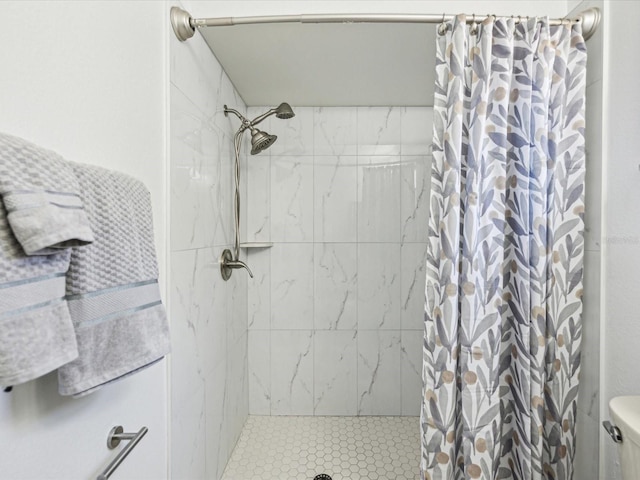 bathroom featuring toilet and a stall shower