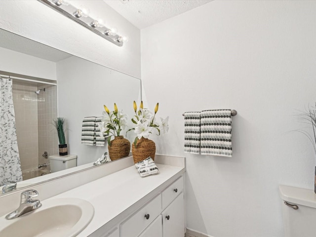 bathroom with vanity, a textured ceiling, shower / bathtub combination with curtain, and toilet