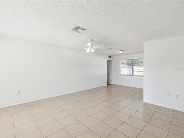 spare room with a textured ceiling, visible vents, and ceiling fan