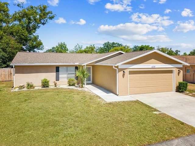 single story home with an attached garage, fence, a front yard, and stucco siding