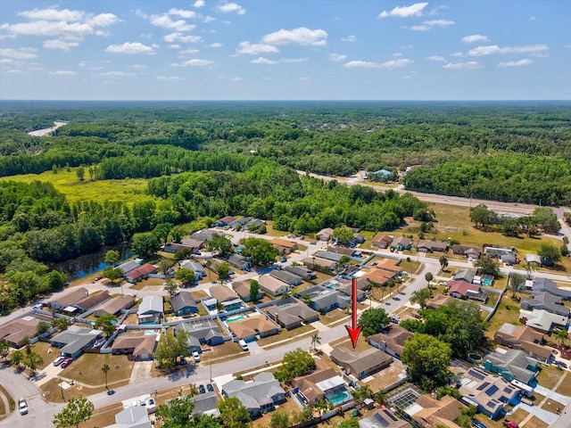 birds eye view of property with a view of trees and a residential view