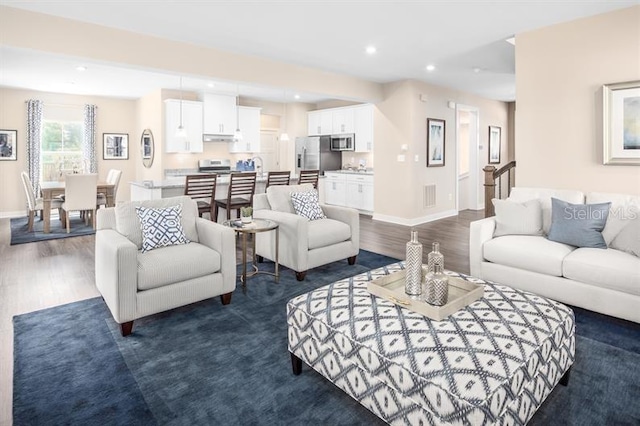 living area featuring baseboards, recessed lighting, dark wood-style flooring, and visible vents