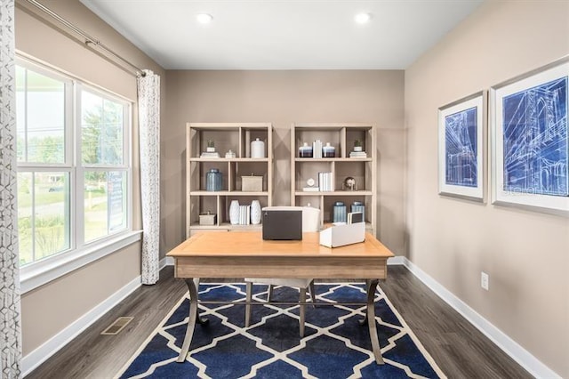 home office with plenty of natural light, dark wood-style flooring, and baseboards