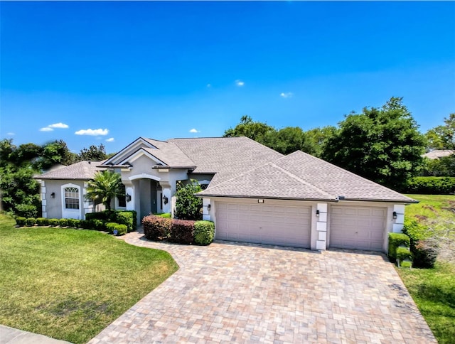 3464 Misty View Dr, Spring Hill, FL 34609 - ranch-style house with an attached garage, a front lawn, decorative driveway, stucco siding, and a shingled roof
