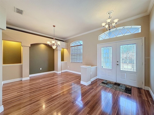 3464 Misty View Dr, Spring Hill, FL 34609 - entrance foyer with a chandelier, wood finished floors, baseboards, and crown molding