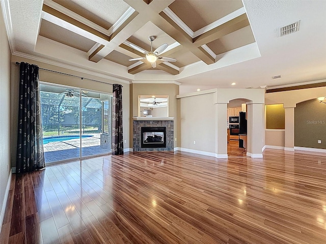 3464 Misty View Dr, Spring Hill, FL 34609 - unfurnished living room with a ceiling fan, arched walkways, ornamental molding, wood finished floors, and baseboards