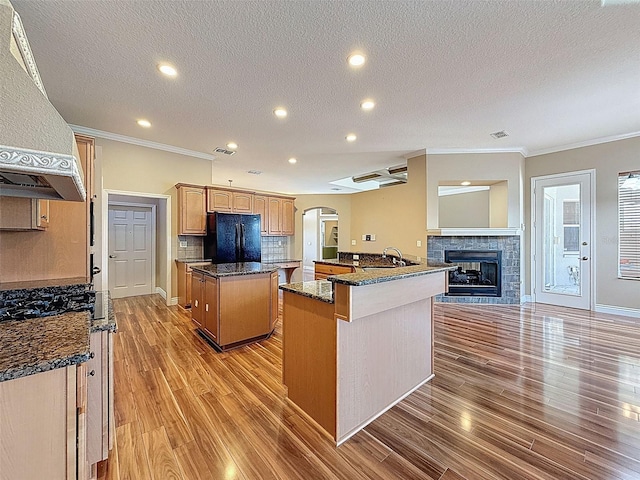 3464 Misty View Dr, Spring Hill, FL 34609 - kitchen with a center island, freestanding refrigerator, ornamental molding, arched walkways, and range hood