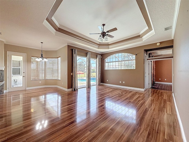 3464 Misty View Dr, Spring Hill, FL 34609 - unfurnished room featuring crown molding, a chandelier, a tray ceiling, ceiling fan, and wood finished floors