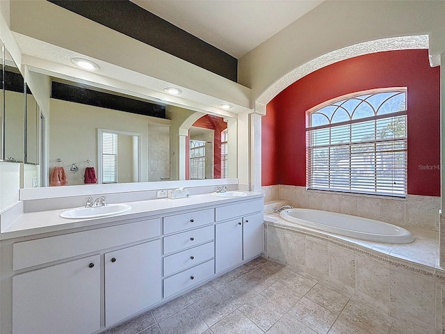 3464 Misty View Dr, Spring Hill, FL 34609 - bathroom featuring a garden tub, plenty of natural light, double vanity, and tile patterned floors