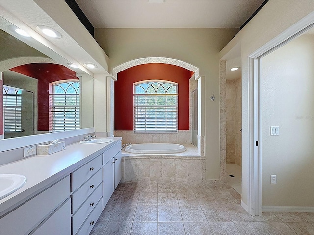3464 Misty View Dr, Spring Hill, FL 34609 - bathroom featuring healthy amount of natural light, a stall shower, a bath, double vanity, and recessed lighting