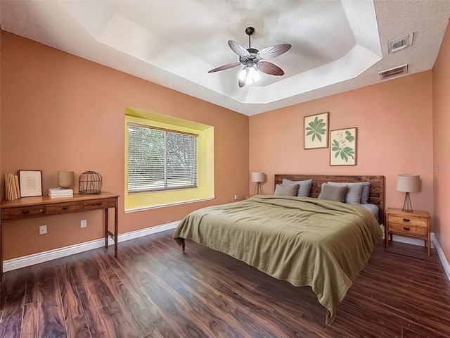 3464 Misty View Dr, Spring Hill, FL 34609 - bedroom featuring a tray ceiling, wood finished floors, baseboards, and ceiling fan