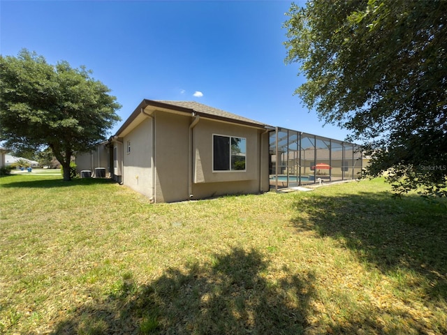 3464 Misty View Dr, Spring Hill, FL 34609 - back of house with a yard, stucco siding, an outdoor pool, and a lanai