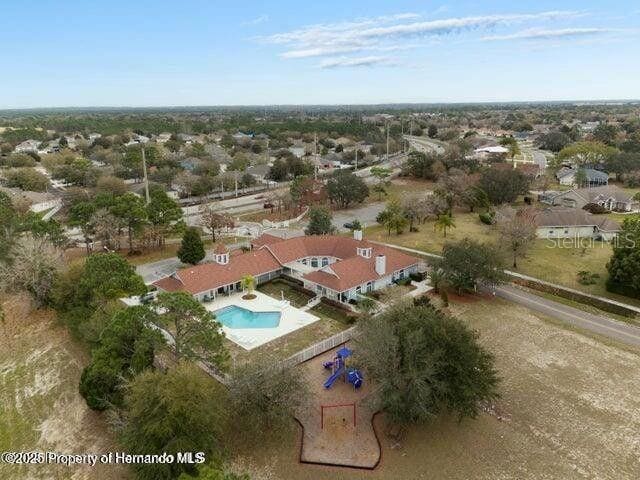 3464 Misty View Dr, Spring Hill, FL 34609 - view of property location with a pool and nearby suburban area