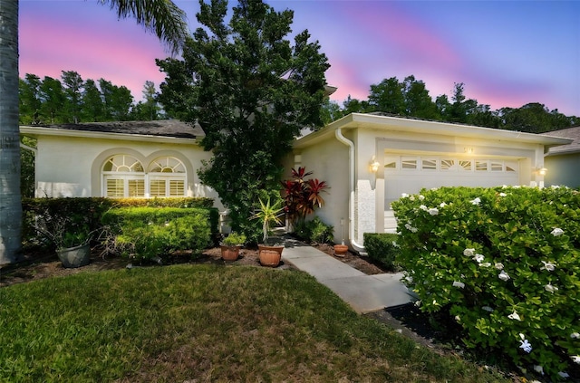 view of front of house featuring an attached garage and stucco siding