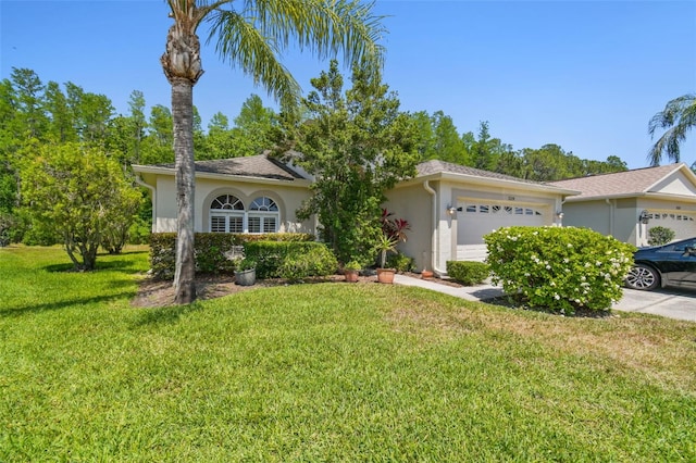 view of front of house with stucco siding, driveway, a front yard, and a garage