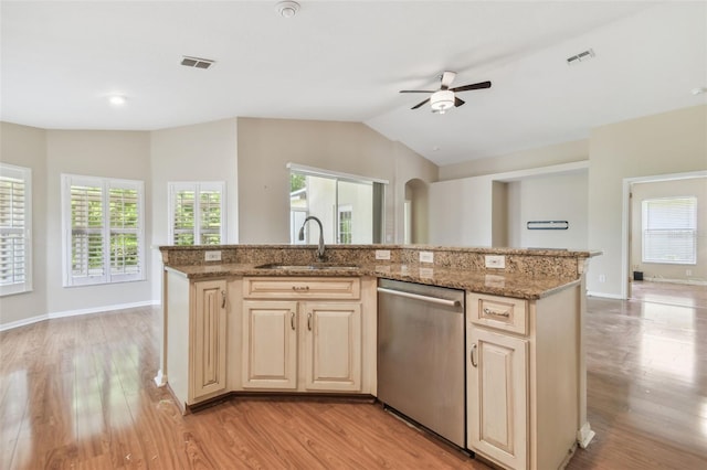 kitchen featuring a sink, stainless steel dishwasher, open floor plan, and visible vents