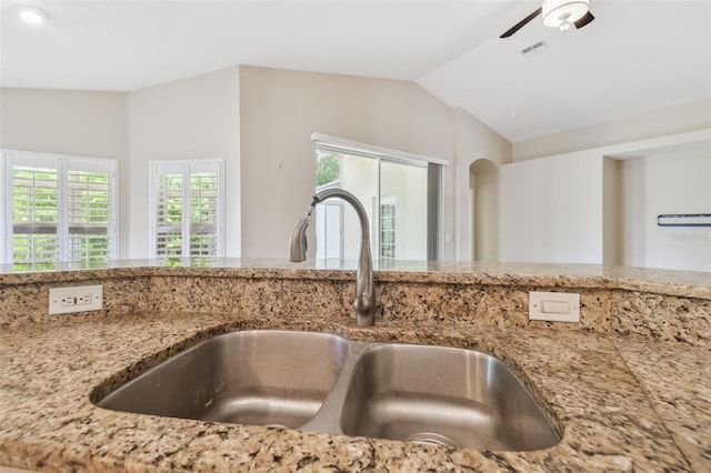 interior details featuring visible vents, a sink, a ceiling fan, and light stone countertops