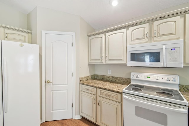 kitchen featuring white appliances, light wood-style flooring, and cream cabinetry