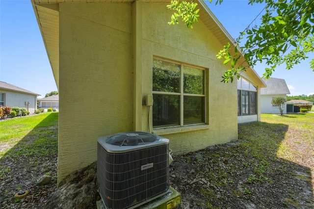 exterior space featuring stucco siding and cooling unit