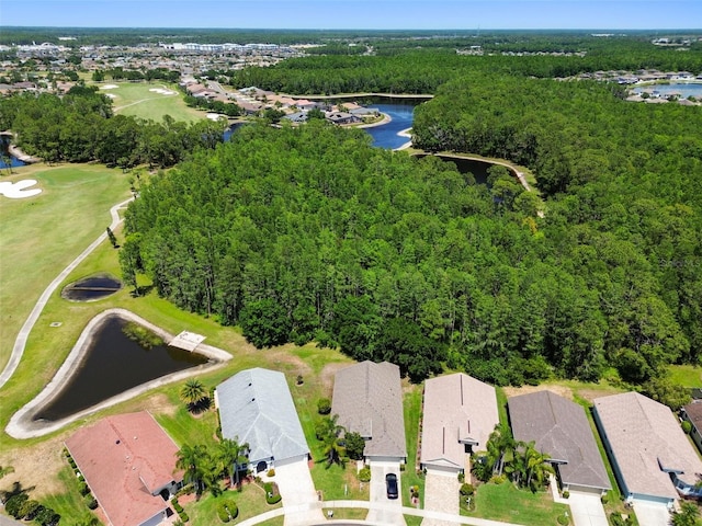 birds eye view of property with a water view, a residential view, and a wooded view