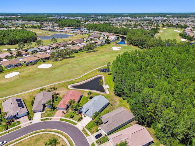 drone / aerial view with a water view, view of golf course, and a residential view