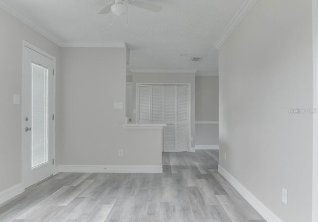 10859 William And Mary Ct, Orlando, FL 32821 - spare room with a ceiling fan, visible vents, crown molding, wood finished floors, and baseboards